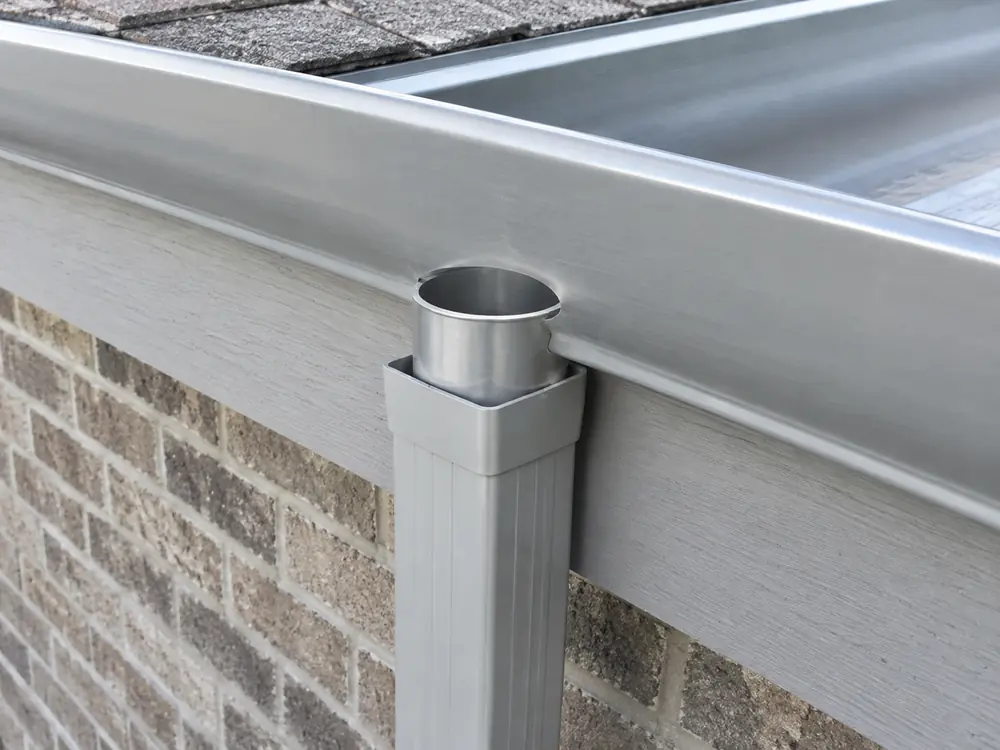 Eavestrough outlet aligned with a downspout