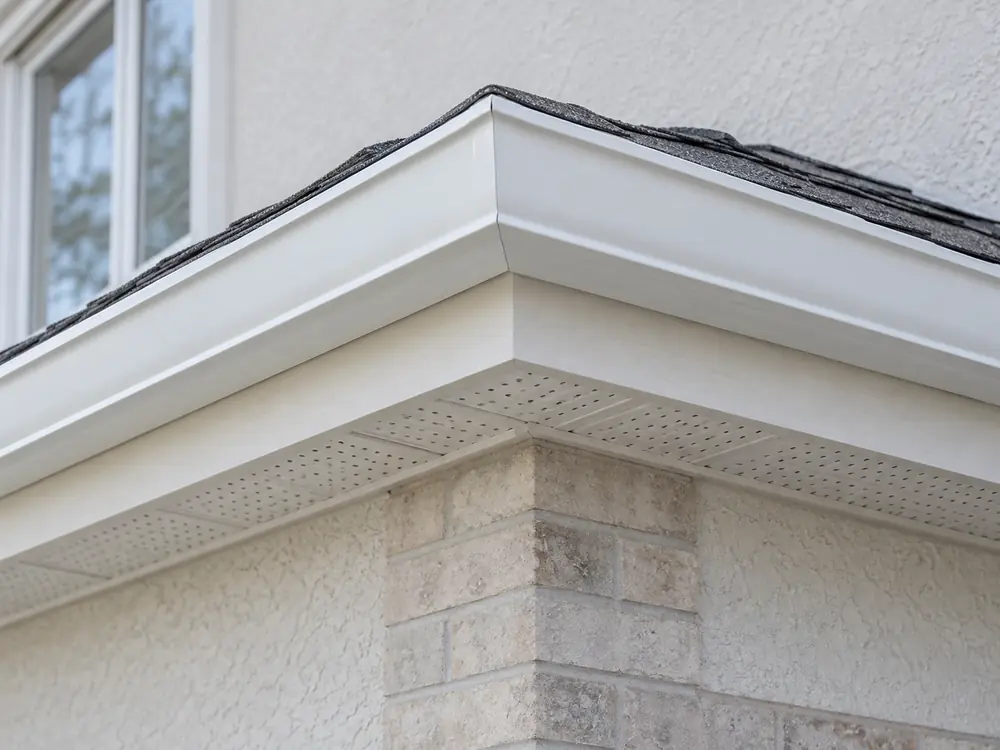White eavestrough outside corner below light fascia